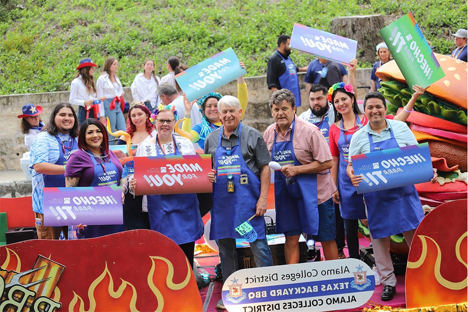 People on the Alamo Colleges District Fiesta River Parade Float